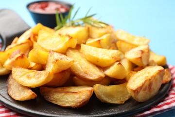 Tasty baked potatoes on light blue table, closeup