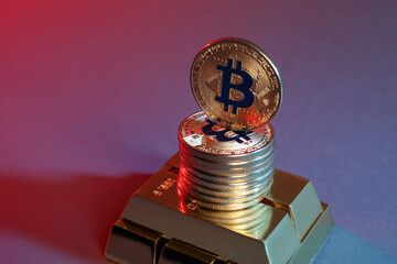 Bitcoins and gold bars on color background in red light, closeup
