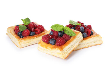 Yummy puff pastries with berries and mint isolated on white