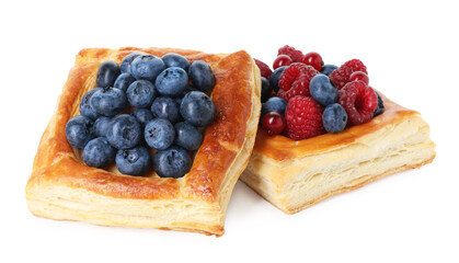 Yummy puff pastries with berries isolated on white