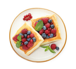 Tasty puff pastries with berries and mint isolated on white, top view