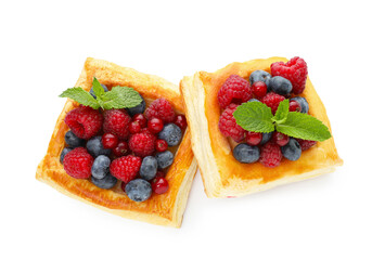 Yummy puff pastries with berries and mint isolated on white, top view