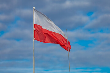 The flag of the Republic of Poland, the white and red flag on the roof of the office, the flag