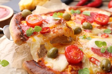 Taking piece of delicious pizza with cheese, tomatoes and olives at table, closeup
