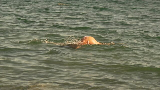 Swimming water ocean, person swims in ocean for leisure during daytime
