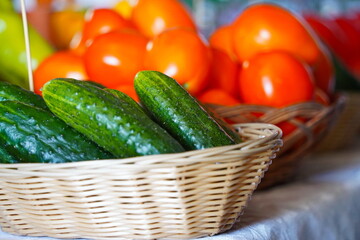 A few cucumbers in a wicker basket. Harvesting.