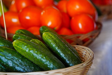 A few cucumbers in a wicker basket. Harvesting.