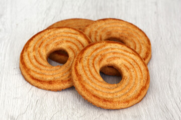 Ring-shaped shortbread cookies on a light background – breakfast or snack sweets