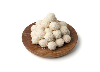 Coconut candies pile, coco ball. White truffle ball, indian ladoo or laddu with sweet cream