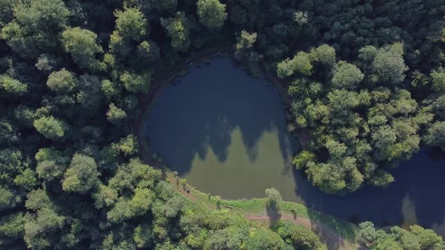 Top down view of a lake surrounded by dense forestry in Dilijan, Armenia. Lake Parz tourist destination for hiking and boating.