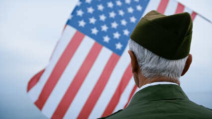 Old Veteran Soldier Looking Up At The USA Flag