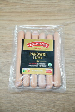 Pack of Wędliniarnia Premium Sausages on a Wooden Table