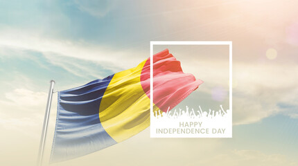 Chad flag waving proudly under a bright sky with text happy independence day. Chad national flag...