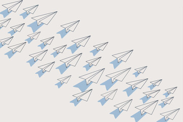 Obraz premium Paper airplanes arranged diagonally on a white surface with shadows forming a dynamic composition