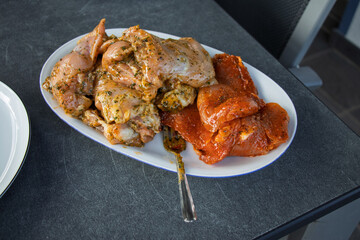 Grilled marinated chicken with dried tomatoes served on white plate - home cooking