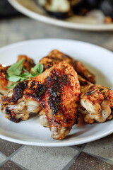 Delicious grilled chicken wings served on a white plate, ready to eat.