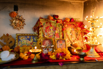 Fototapeta premium holy idol of hindu god and goddess at home temple decorated with holy offerings at indoor