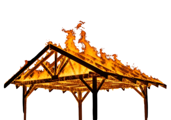 Intense flames engulf a wooden structure's roof, creating a dramatic scene of destruction at night.