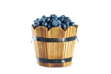 Ripe fresh blueberries in wooden tub isolated on white.