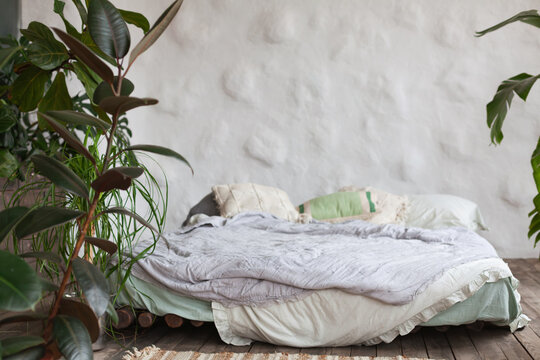 Mindful living space with a cozy bed surrounded by greenery in a tropical hotel room