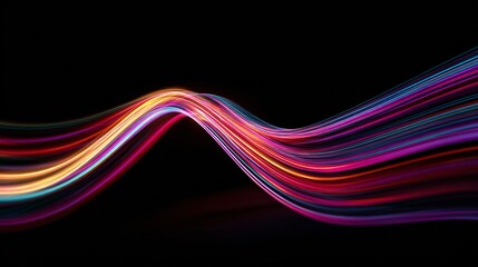 Fluid motion of curved light streaks glowing with vibrant neon colors in wave form