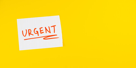 Urgent tag on white paper isolated on flat yellow background with copy space, Important, urgent...