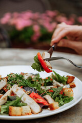 Close-up of a delicious chicken salad being eaten with a fork.