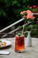 Refreshing cocktail with flowers on a table