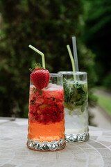 Refreshing cocktails with strawberries and mint on a sunny day