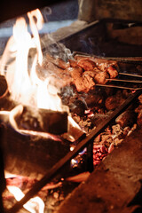 Grilled meat on skewers over a fire