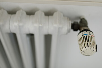 High-quality photo of a white radiator thermostat. Perfect for home, energy, and comfort themes.