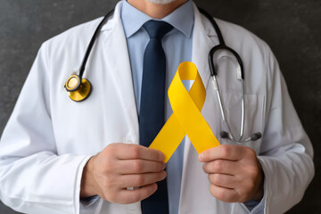 Doctor in white coat holding yellow ribbon, isolated stock photo with transparent background for health awareness campaigns
