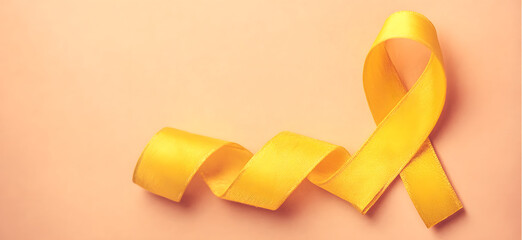 Yellow ribbon on flat yellow background, symbolizing cancer awareness with copy space for health campaigns and design use
