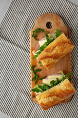 Homemade French Ham and Brie Baguette with Arugula Greens, top view. Copy space.
