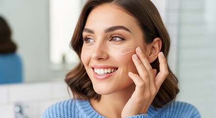 A happy young woman applies anti-aging gel to her face, demonstrating her daily skincare routine with a radiant smile, perfect for a beauty and health ad.
