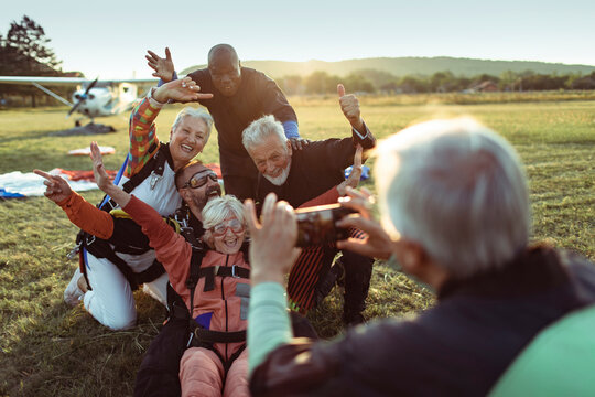 Group of seniors celebrating after skydiving