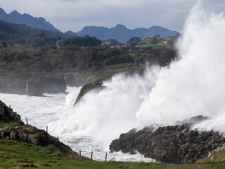 Big waves crashing on rocky coast in asturias, spain