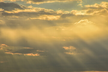 Sunset sky painted in fire and pastel clouds above horizon