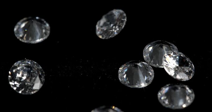 Jewelry zirconia stones on a dark background. Artificial zirconium stone is picked up with tweezers.