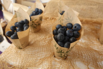 Fresh blueberries served in eco-friendly paper cones at farmers market