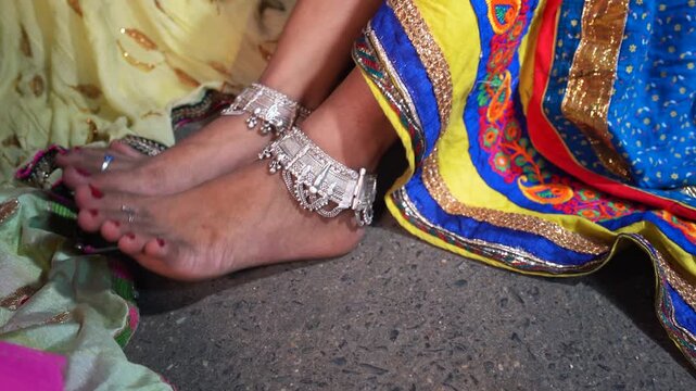 Close-up of an Indian Woman's Feet Wearing Traditional Silver Anklets (Payal) and a Colorful Lehenga Dress