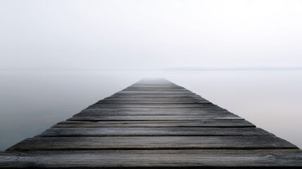 Fototapeta premium Long wooden pier extending into the distance. the pier is made of wooden planks that are weathered and aged, and the water below is calm and still.