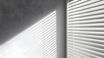 Sunlight stripes cast across grey textured wall and white venetian blinds shadow pattern