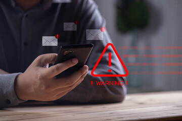 Person holding smartphone with red warning alert sign, email scam, phishing attack, online fraud,...