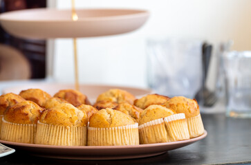 Freshly baked muffins arranged on a plate, showcasing delicious homemade bakery treats. Perfect image for concepts of food, dessert, breakfast, pastry, snack, and sweet indulgence in daily life.