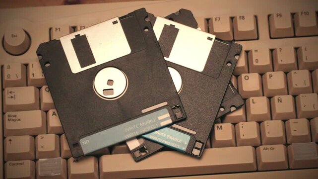 Floppy disc FDD close up, Using diskette for old PC computer macro. Archive programme or Music recorder, playing retro computer games. Vintage device for office, obsolete technology. 