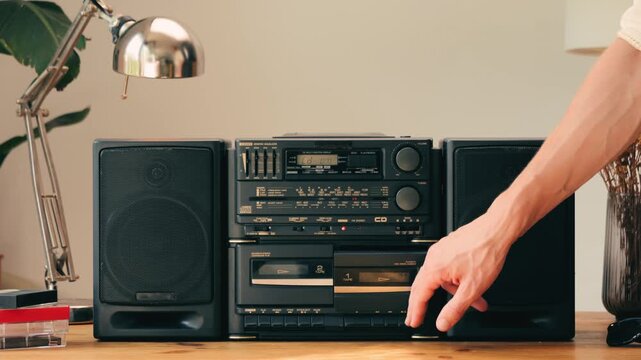Retro radio tape recorder, audio cassette close-up. Listening to music, old radio boom box player, macro of vintage music listening. 
