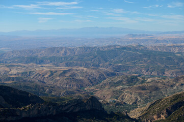 Fototapeta premium Expansive Landscape View of Mountain Ridges and Valleys Under Blue Sky
