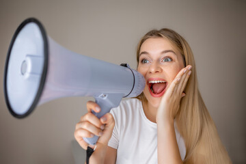 Excited woman using a megaphone expressing enthusiasm and creativity in communication