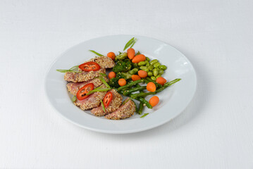tuna in sesame in a white plate on a white background 